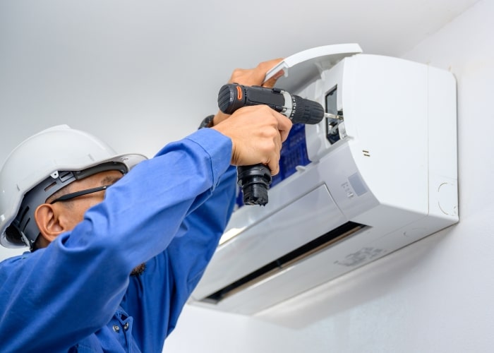 Tech working on mini split system.